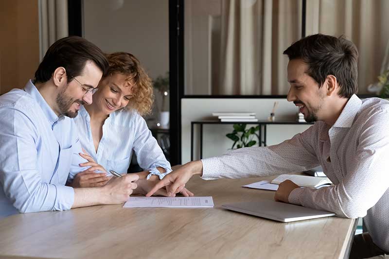 happy-couple-clients-signing-house-buying-rent-contract-insurance-agreement-filling-bank-papers-mortgage-loan-meeting-with-lawyer-broker-realtor-real-estate-agent-office